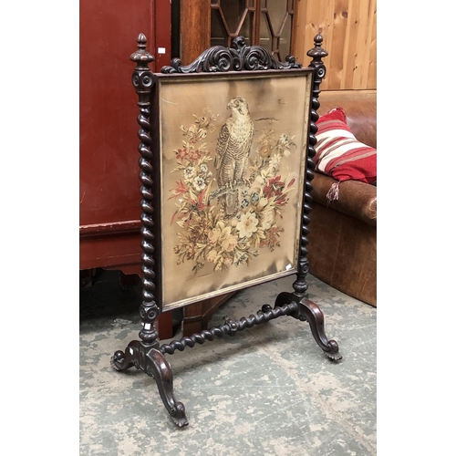 697 - A 19th century mahogany fire screen, spirally turned, the panel with embroidered Sparrowhawk and flo... 