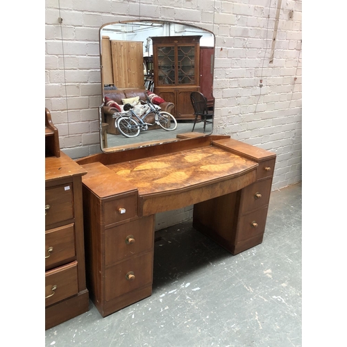 754 - An Art Deco walnut veneer dressing table with shaped mirror, 132x46x150cm (74cm excluding mirror)