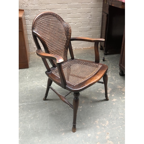 755 - A unusual early 20th century bergere caned armchair, the caned back having curved sides, 60cmW