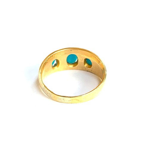 66 - A late 19th/early 20th century gold gypsy ring set with turquoise coloured cabochons, marks rubbed b... 