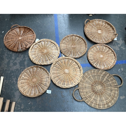 801 - Eight wicker trays/shallow baskets, the largest 43cmD