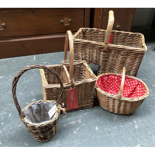 806 - A wicker staircase storage basket; together with three further wicker baskets with handles (4)