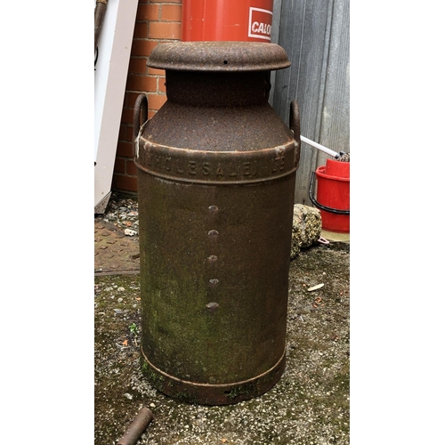 816 - A vintage United Dairies Wholesale ltd milk churn; together with two carriage lanterns and tools