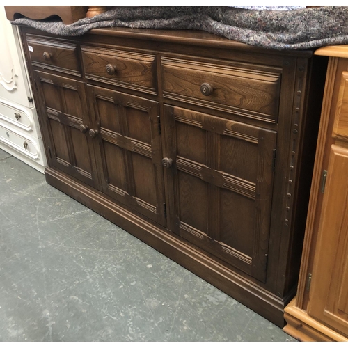 726 - An Ercol elm dresser base, three drawers and three panelled doors, 140x51x85cmH