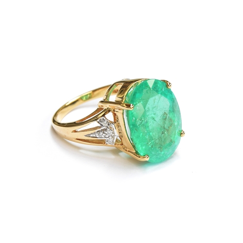 38 - An impressive 18ct gold ring set with a large Muzo Colombian emerald, the oval cut emerald 17x12mm a... 