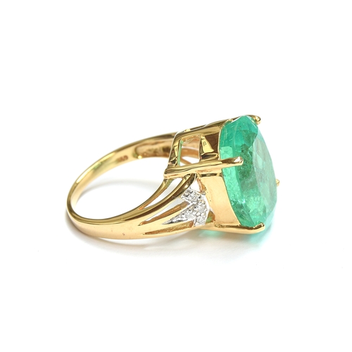 38 - An impressive 18ct gold ring set with a large Muzo Colombian emerald, the oval cut emerald 17x12mm a... 