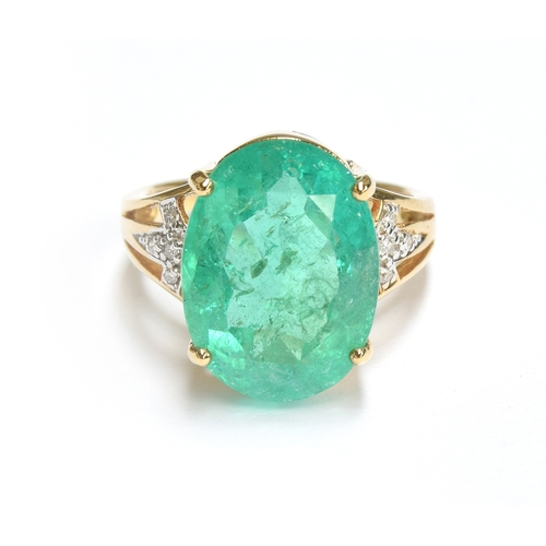 38 - An impressive 18ct gold ring set with a large Muzo Colombian emerald, the oval cut emerald 17x12mm a... 