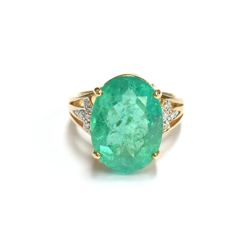 38 - An impressive 18ct gold ring set with a large Muzo Colombian emerald, the oval cut emerald 17x12mm a... 