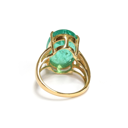 38 - An impressive 18ct gold ring set with a large Muzo Colombian emerald, the oval cut emerald 17x12mm a... 