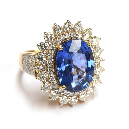 31 - An 18ct gold sapphire and diamond cluster ring, the large Sri Lankan sapphire 14x10mm weighing appro... 