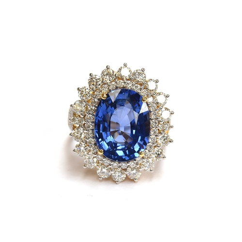 An 18ct gold sapphire and diamond cluster ring, the large Sri Lankan sapphire 14x10mm weighing approx. 8.1cts, surrounded by diamonds totalling 1.87cts, size N 1/2, gross weight 12.8g, purchased by the vendor in 2016 for £12,000

Provenance: private collection, Branksome, Poole