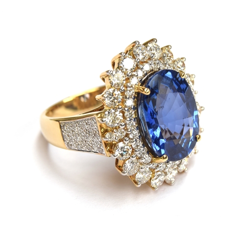 31 - An 18ct gold sapphire and diamond cluster ring, the large Sri Lankan sapphire 14x10mm weighing appro... 