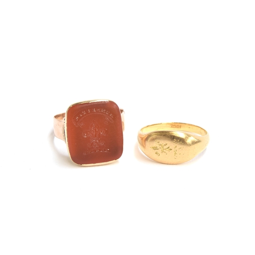 1 - A 14ct gold mounted intaglio seal ring, the carnelian carved with a fleur de lis and the motto 'Honn... 