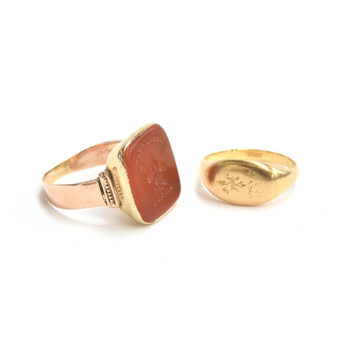 1 - A 14ct gold mounted intaglio seal ring, the carnelian carved with a fleur de lis and the motto 'Honn... 