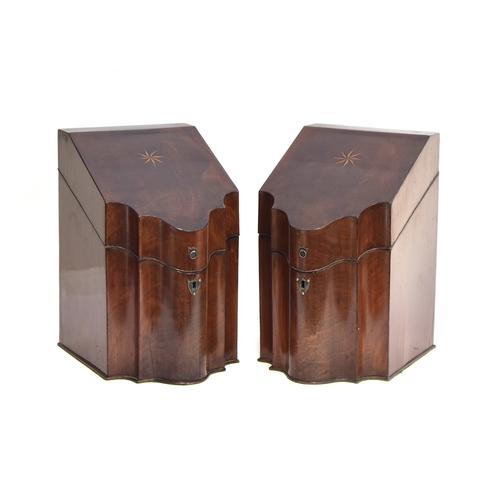 227 - A pair of George III mahogany serpentine knife boxes, the lids with star marquetry, opening to the o... 