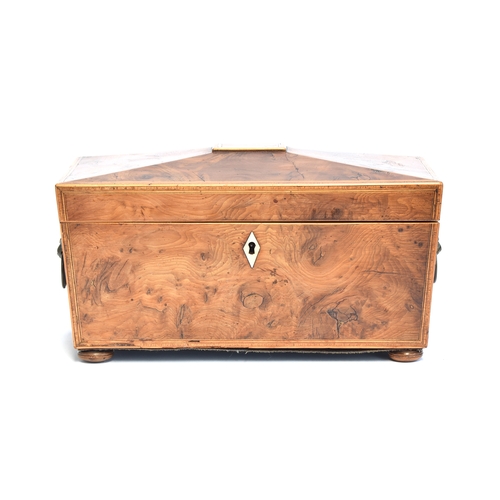 224 - A Regency yew wood tea caddy of sarcophagus form, the tablet top opening to twin canisters and glass... 