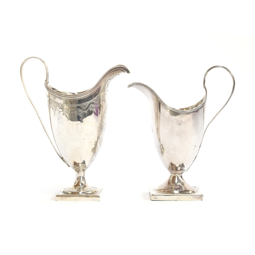 188 - Two George III silver helmet form milk jugs, one with bright cut decoration, each on a square steppe... 