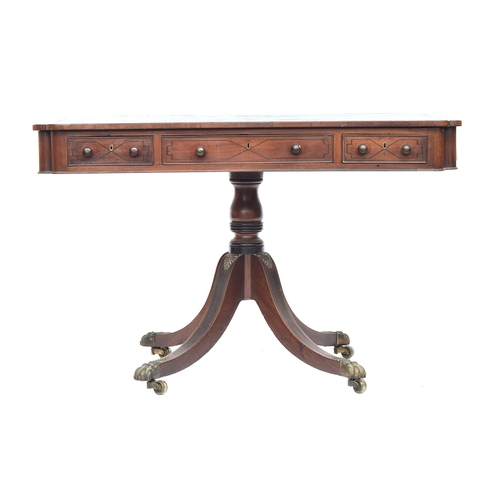 410 - A Regency mahogany library table, the rectangular top with re-entrant corners, inset tooled leather ... 