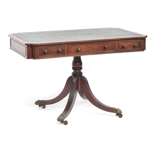 410 - A Regency mahogany library table, the rectangular top with re-entrant corners, inset tooled leather ... 