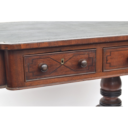 410 - A Regency mahogany library table, the rectangular top with re-entrant corners, inset tooled leather ... 