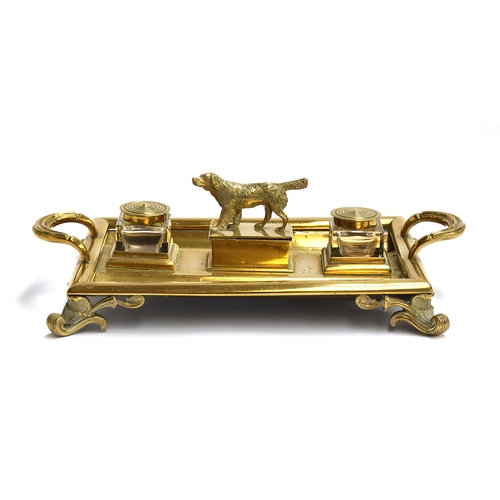 210 - A large Victorian brass desk inkstand with two cut glass lidded inkwells and a central box surmounte... 