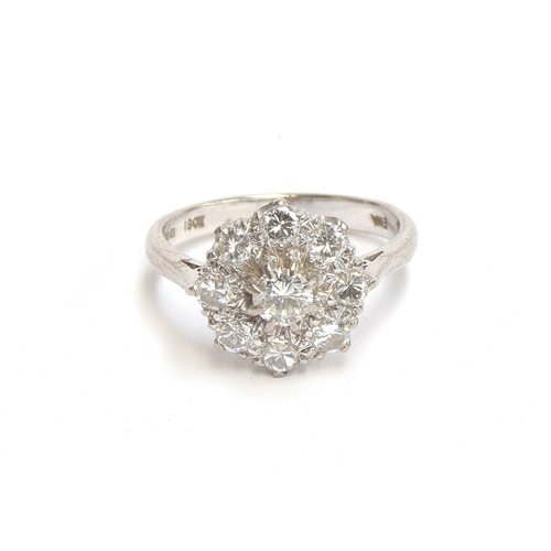 18 - An 18ct white gold diamond cluster ring, total diamond carat approx. 1.5cts, size N 1/2, hallmarked ... 