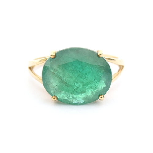 46 - A 9ct gold ring set with an oval cut Bahia emerald, approx 5.3cts, size N 1/2, 2.5g purchased by the... 