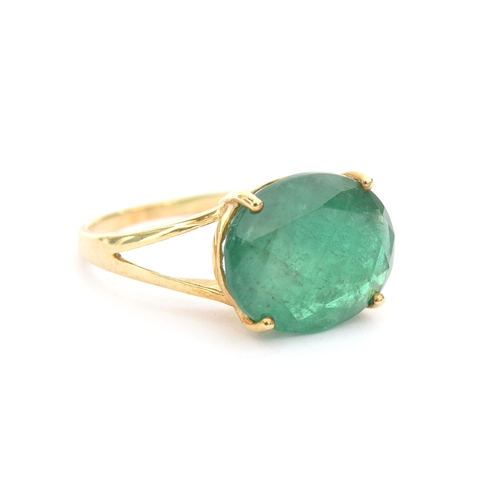 46 - A 9ct gold ring set with an oval cut Bahia emerald, approx 5.3cts, size N 1/2, 2.5g purchased by the... 