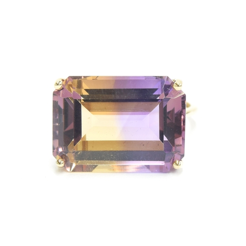 134 - A 9ct gold ametrine cocktail ring, the emerald cut Anahi ametrine weighing 15.2cts, size O, 5.1g

Pr... 