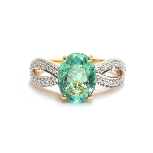 42 - An 18ct gold ring set with an emerald and diamonds, the oval cut Ethiopian emerald weighing 2.1cts, ... 