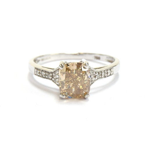 47 - An 18ct white gold ring set with a large Argyle champagne diamond, the cushion cut diamond weighing ... 