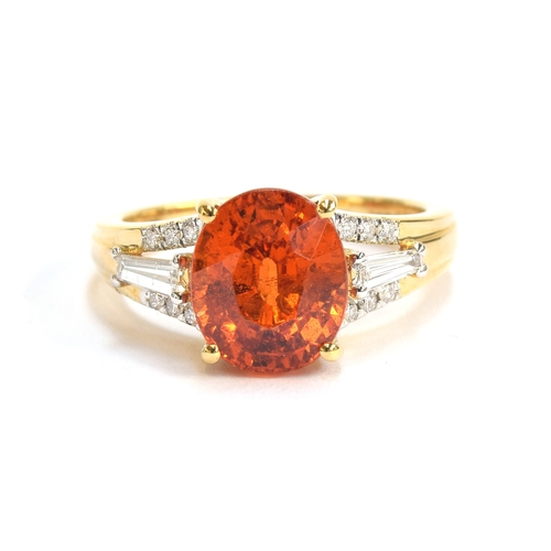 97 - An 18ct gold ring set with a Mandarin garnet and diamonds, the oval cut garnet 5cts, flanked by bagu... 