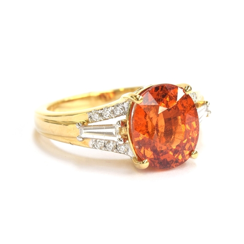 97 - An 18ct gold ring set with a Mandarin garnet and diamonds, the oval cut garnet 5cts, flanked by bagu... 