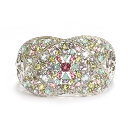 90 - A heavy 18ct white gold, tourmaline and diamond bangle, set with a total of 25.2cts of stones includ... 