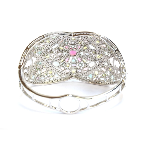 90 - A heavy 18ct white gold, tourmaline and diamond bangle, set with a total of 25.2cts of stones includ... 