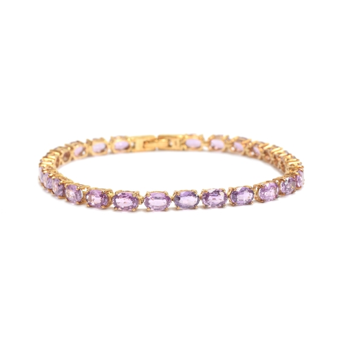 93 - A 9ct gold mounted Ceylon purple sapphire bracelet, the oval cut sapphires totalling 14.7cts, 19cm l... 