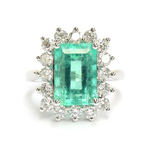 32 - A platinum mounted emerald and diamond cluster ring, the Boyaca Columbian emerald weighing 5.75cts a... 