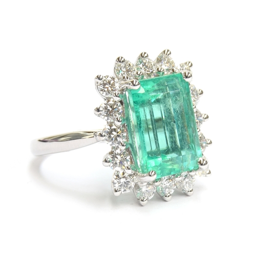 32 - A platinum mounted emerald and diamond cluster ring, the Boyaca Columbian emerald weighing 5.75cts a... 