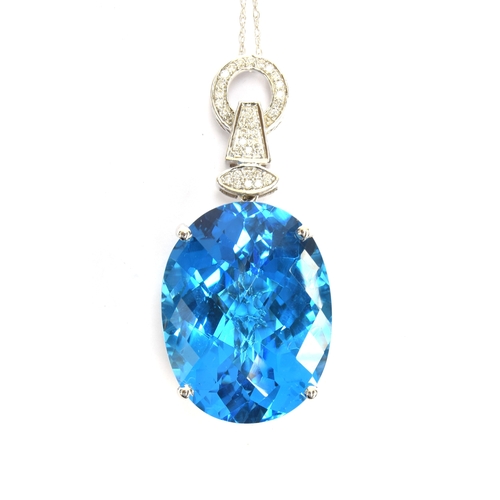 88 - An 18ct white gold mounted Swiss blue topaz and diamond pendant, the topaz weighing 62.7cts and meas... 