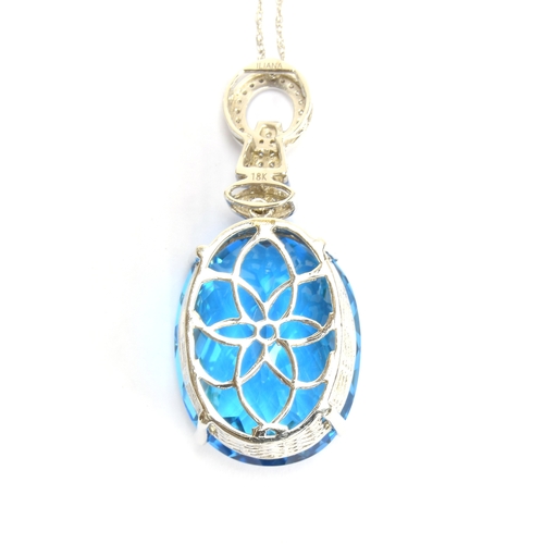 88 - An 18ct white gold mounted Swiss blue topaz and diamond pendant, the topaz weighing 62.7cts and meas... 