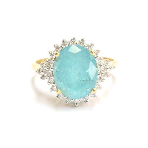 80 - An 18ct gold Brazilian Paraiba tourmaline and diamond cluster ring, the oval cut tourmaline weighing... 