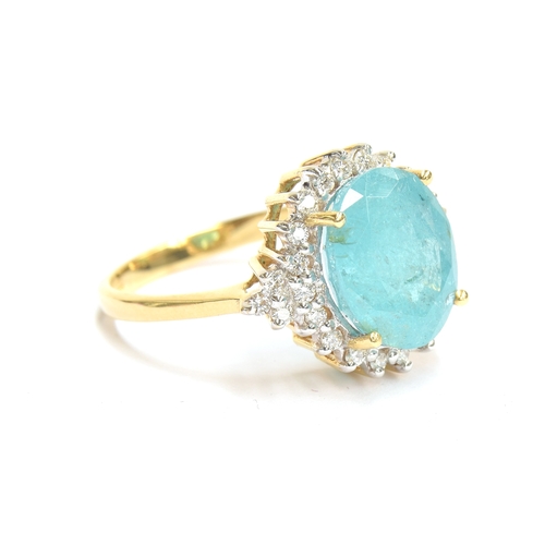 80 - An 18ct gold Brazilian Paraiba tourmaline and diamond cluster ring, the oval cut tourmaline weighing... 