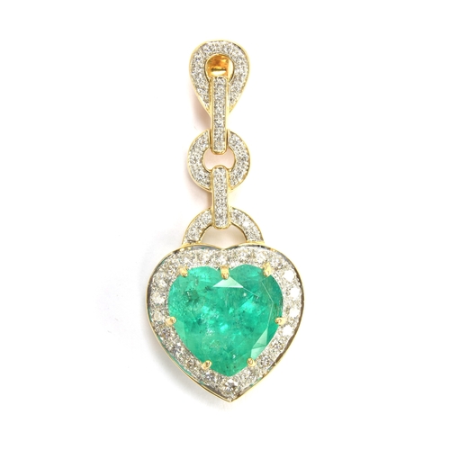 43 - An 18ct gold emerald and diamond pendant, the large heart cut Colombian emerald weighing 10.8cts and... 