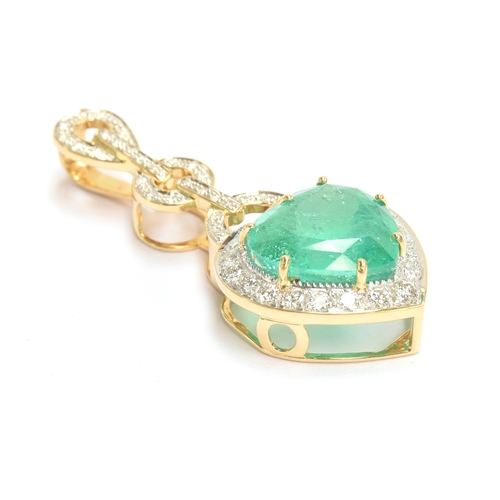 43 - An 18ct gold emerald and diamond pendant, the large heart cut Colombian emerald weighing 10.8cts and... 