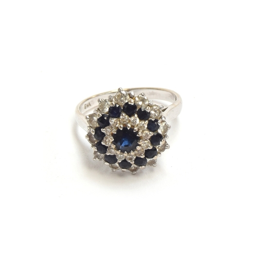 19 - An 18ct white gold, sapphire and diamond cluster ring, the ring head 1.5cm diameter, size M, 5.4g