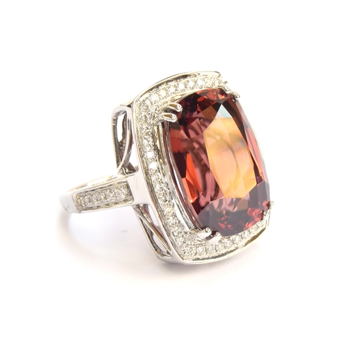 98 - An 18ct white gold ring set with a large Ratanakiri red zircon and diamonds, the zircon 19.5cts and ... 