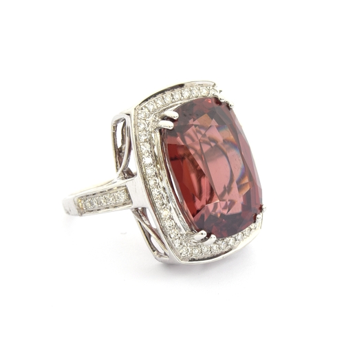 98 - An 18ct white gold ring set with a large Ratanakiri red zircon and diamonds, the zircon 19.5cts and ... 