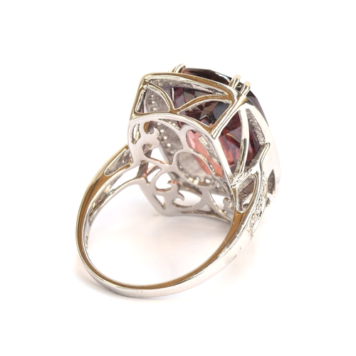 98 - An 18ct white gold ring set with a large Ratanakiri red zircon and diamonds, the zircon 19.5cts and ... 