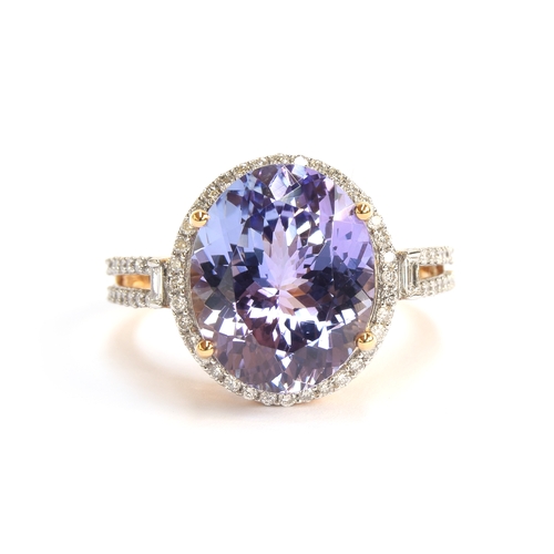 109 - An 18ct gold ring set with a pink tanzanite and diamonds, the oval cut tanzanite 6.1cts and 13.2x10.... 