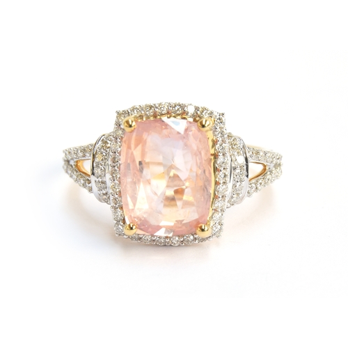 99 - An 18ct gold padparadscha sapphire and diamond ring, the cushion cut sapphire 4.7cts and measuring 1... 